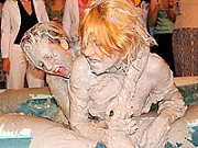 Cute teen amateur girls wrestling each other in a mud pit