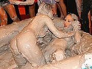 Erotic chicks wrestling each other and covered in thick mud