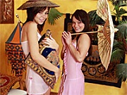 Two cute brunette teens playing oriental dildo sex games