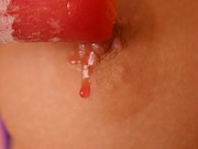 Young slut caressing her nipples with an ice cream