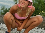 Innocent Debbie shows off her sweet body on the sunny beach