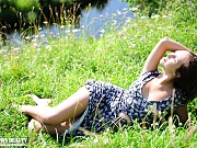 Busty beauty queen enjoys the warm sunshine beside crystal clear creek. Natural beauty in natural environment. The best combination.