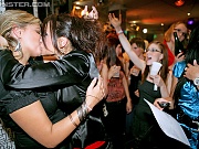 Two horny lesbians at a large sex party playing with cream