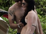 Playful Lindsay Lohan enjoys surfing on the beach in black bikini