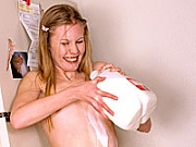 Teenage blonde loves pouring milk over her fine young body