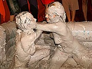 Hot naked wrestling hotties get completely covered in mud