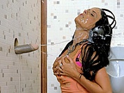 Hard rock chick sucking a rubber cock through a gloryhole