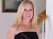 Busty mature Monique slides black dress off her tight body.
