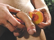 Thomas eats a peach while his uncut cock hangs out.