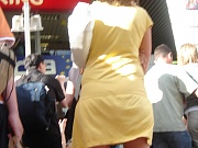 Yellow mini cannot save her from being voyeured. Up skirt