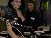 Brunette on the bike has her boobs seen under top