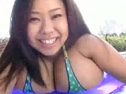This time Fuko poses her gigantic tits near the swimming pool. A sexy bikini reveals all her body and what a pair of monster natural tits she has!