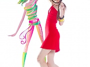 Gorgeous dark haired teen girl with red glasses in the shape of hearts posing with tape recorder. 