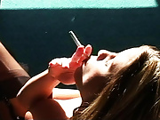 Erotic vixen Georgia sits on her living room floor and smokes