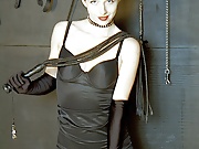 Redhead is surrounded by all the implements to be used in her discipline 