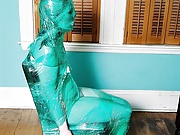 A woman is mummified in plastic wrap