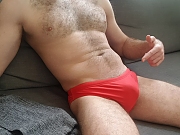 Amateur guys wearing red speedos at the beach and pool.