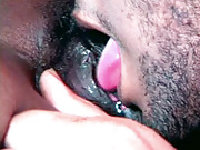 Busty black chick gets arousing tongue-licking satisfaction.
